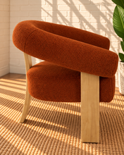 Load image into Gallery viewer, Kourtney burnt orange textured accent chair with curved flared arms, cushioned seat and natural wood legs.