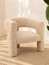 Load image into Gallery viewer, Kristine accent chair upholstered in textured cream and rust tweed with curved arms, open back details, and rounded cushioned seat.