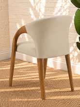 Load image into Gallery viewer, Kyra greige vegan leather dining armchair with curved back, sculpted solid ash wood arms and legs, and cushioned seat.
