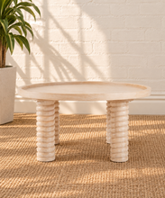 Load image into Gallery viewer, Lainey natural wood round coffee table with raised rim, subtle wood grain and four chunky ring-turned legs.