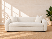 Load image into Gallery viewer, Image 1 of 5: Leighton upholstered sofa in Snow Cream sherpa with rounded silhouette, sloped arms, bench seat, and black legs
