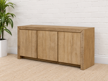 Load image into Gallery viewer, Levi three-door media cabinet in natural acacia wood with clean handle-free doors, visible wood grain and a low framed base.