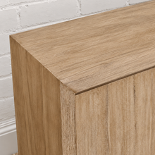 Load image into Gallery viewer, Levi three-door media cabinet in natural acacia wood with clean handle-free doors, visible wood grain and a low framed base.