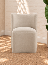 Load image into Gallery viewer, Lizbeth sand chenille accent chair with curved winged backrest, cushioned seat and fully upholstered rounded base.