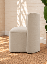 Load image into Gallery viewer, Lizbeth sand chenille accent chair with curved winged backrest, cushioned seat and fully upholstered rounded base.