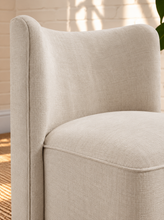 Load image into Gallery viewer, Lizbeth sand chenille accent chair with curved winged backrest, cushioned seat and fully upholstered rounded base.