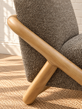 Load image into Gallery viewer, Lucia lounge chair with textured mocha upholstery, rounded seat and back, and sculptural curved natural wood sled frame