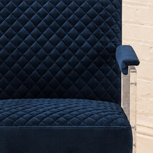 Load image into Gallery viewer, Lucian navy blue velvet accent chair with diamond-quilted upholstery, padded armrests and clear acrylic legs.
