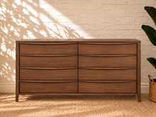 Load image into Gallery viewer, Image 1 of 4: Luciana 8-Drawer Dresser in Natural Walnut with curved drawer pulls, rounded corners, and visible wood grain