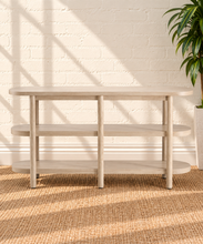 Load image into Gallery viewer, Malie natural wood open shelf console with rounded ends, two open lower shelves and slender vertical wood supports.