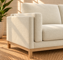 Load image into Gallery viewer, Image 4 of 4: Maraiah upholstered sofa in Oat Milk Mélange Chenille with low-profile silhouette and weathered wood base
