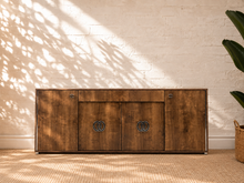 Load image into Gallery viewer, Maren Italian four-door credenza with gloss-finished rovere wood grain, center drawer, and chrome and black C-shaped hardware.