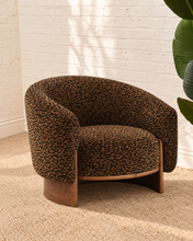 Load image into Gallery viewer, Melinda brown leopard print accent chair with rounded wraparound back, curved arms, deep upholstered seat, and sculptural silhouette.