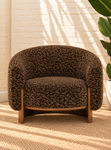 Load image into Gallery viewer, Melinda brown leopard print accent chair with rounded wraparound back, curved arms, deep upholstered seat, and sculptural silhouette.