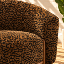 Load image into Gallery viewer, Melinda brown leopard print accent chair with rounded wraparound back, curved arms, deep upholstered seat, and sculptural silhouette.