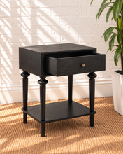 Load image into Gallery viewer, Mina natural black one-drawer nightstand with round metal knob, spindle-detailed wood legs and an open lower storage shelf.