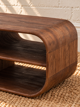 Load image into Gallery viewer, Montana natural brown mindi wood coffee table with a rectangular top, rounded corners, visible wood grain, and sculptural curved base.