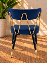 Load image into Gallery viewer, Morse dining chair in Royal Navy velvet with matte black metal legs and gold frame and leg tip details