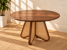 Load image into Gallery viewer, Nabi round dining table in Natural Brown with walnut finish and sculptural natural cane-inset pedestal base.