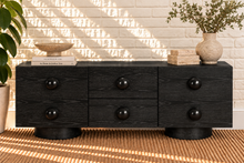 Load image into Gallery viewer, Norris Charcoal buffet credenza with oversized orb knobs, central drawers, cabinet storage, and rounded pedestal base
