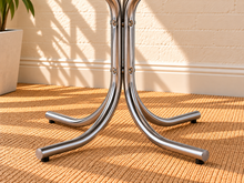 Load image into Gallery viewer, Image 4 of 4: Ortega 42-inch round dining table with Ivory laminate top, layered chrome trim, and curved polished chrome pedestal base
