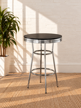 Load image into Gallery viewer, Image 1 of 5: Ortega Retro Bar Table with Black round laminate top, layered Chrome apron, flared legs, and circular support rings