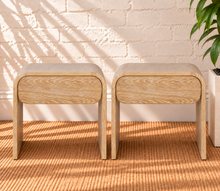Load image into Gallery viewer, Pair of Blaise Blonde Oak nightstands in solid white oak with curved designs, integrated drawers, and cerused brushed wood grain.