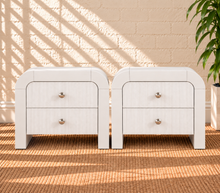 Load image into Gallery viewer, Pair of Blanca 2-drawer ash wood nightstands in Arctic White with curved frames and fluted drawer fronts.