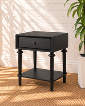 Load image into Gallery viewer, Pair of Mina natural black nightstands with single drawers, round metal knobs, spindle-detailed legs and open lower storage shelves.