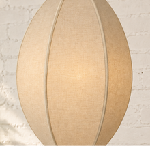 Load image into Gallery viewer, Penny hanging lamp in sand cotton rope with an elongated oval shade, raised vertical ribs, iron frame, and chain suspension.