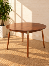 Load image into Gallery viewer, Image 1 of 5: Shop the Perez Round Dining Table, crafted from solid Acacia wood with tapered legs, warm Walnut tones, and refined Brass accents.