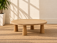 Load image into Gallery viewer, Rae coffee table in natural mango wood with a wide oval tabletop, rounded edges, and sculptural pedestal-style base.