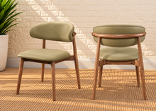 Load image into Gallery viewer, Reed Walnut dining chair upholstered in Desert Khaki vegan leather with curved backrest and solid wood frame