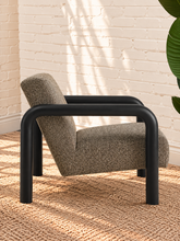 Load image into Gallery viewer, Riviera Onyx lounge chair with textured bouclé upholstery, rounded black wood arms, and padded seat and back