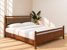 Load image into Gallery viewer, Rocco Queen platform bed with Walnut rubberwood frame, Taupe faux leather upholstered headboard pillow, and decorative leather straps.