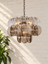 Load image into Gallery viewer, Rocio chandelier with layered clear and smoky sculptural glass pieces suspended from an iron frame and chain.
