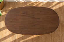 Load image into Gallery viewer, Rohan 79-inch oval dining table in dark walnut solid Mindi wood with rounded tabletop edges and architectural panel legs.