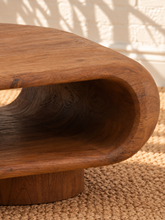 Load image into Gallery viewer, Rolly acacia wood coffee table in natural brown with rounded edges, open shelf, and two cylindrical pedestal feet.