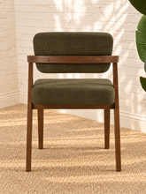 Load image into Gallery viewer, Royce dining armchair with deep olive textured upholstery, curved cushioned back, and walnut-finished solid rubberwood frame.