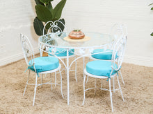 Load image into Gallery viewer, Vintage Wrought Iron Patio Dining Table with Leaf Motif Aqua Cushions and Glass Top