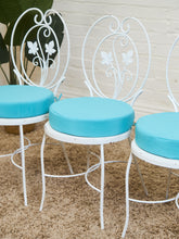 Load image into Gallery viewer, Vintage Wrought Iron Patio Dining Table with Leaf Motif Aqua Cushions and Glass Top