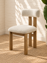 Load image into Gallery viewer, Sandra dining chair with off-white bouclé upholstered seat and backrest, high-density foam cushioning and natural solid ash wood frame.