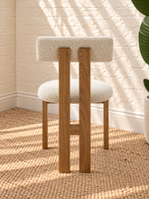 Load image into Gallery viewer, Sandra dining chair with off-white bouclé upholstered seat and backrest, high-density foam cushioning and natural solid ash wood frame.