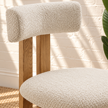 Load image into Gallery viewer, Sandra dining chair with off-white bouclé upholstered seat and backrest, high-density foam cushioning and natural solid ash wood frame.