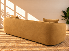 Load image into Gallery viewer, Image 5 of 5: Savino upholstered sofa in Warm Ochre fabric with rounded shelter arms, channel back detailing, and broad cushioned seats