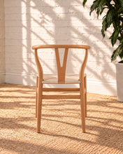 Load image into Gallery viewer, Sculptural blonde tone dining chair with curved wood back, central cutout splat and natural woven cord seat.