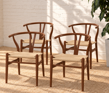 Load image into Gallery viewer, Sculptural walnut-tone dining chair with curved open back, central wood splat and natural woven cord seat.
