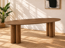Load image into Gallery viewer, Stella sculptural oval dining table in walnut with oak veneer top and rounded three-column pedestal bases