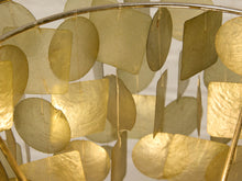 Load image into Gallery viewer, A close-up of a gold-toned hanging ornament or chime made of overlapping translucent square and circular discs suspended from a curved metal frame.