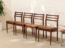 Load image into Gallery viewer, Set of four vintage Danish modern rosewood dining chairs with sculpted ladder backs, tapered legs, and brown upholstered seats.
Era: Mid-20th Century
Style: Danish Modern · Scandinavian · Mid-Century Modern